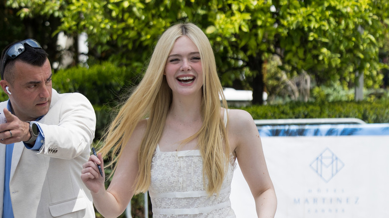 Elle Fanning arriving at event in white dress