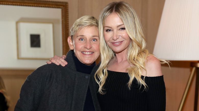 Ellen DeGeneres in a gray jacket and Portia de Rossi in a black top