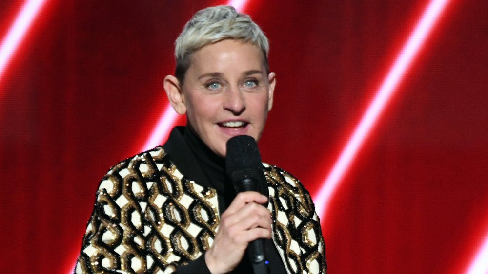 Ellen DeGeneres with a microphone in hand