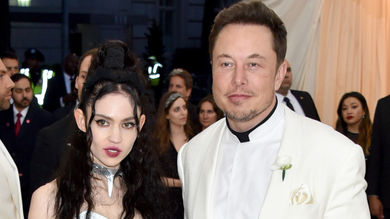 Grimes and Elon Musk smiling.