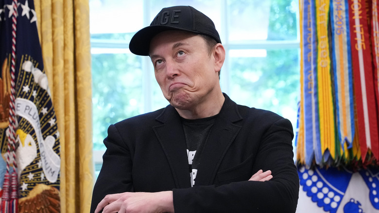Elon Musk making a thinking face in the Oval Office