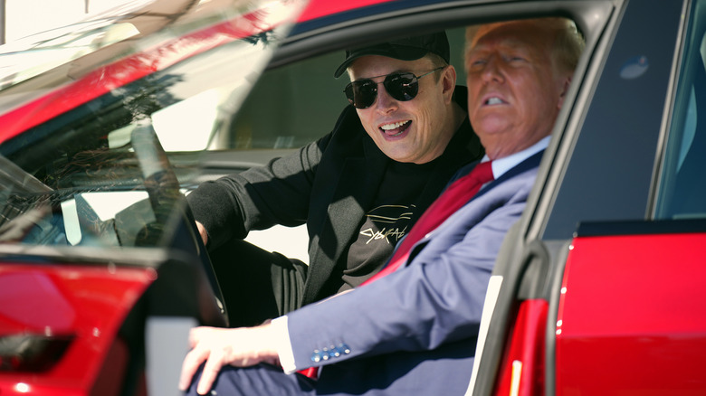 Elon Musk and Donald Trump smiling together in a Tesla