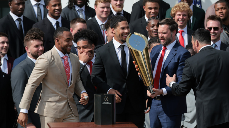 Vice President JD Vance holds the College Football National Championship trophy as he and U.S. President Donald Trump welcome the 2025 College Football National Champions from Ohio State University to the White House during a ceremony on the south lawn on April 14, 2025 in Washington, D.C.