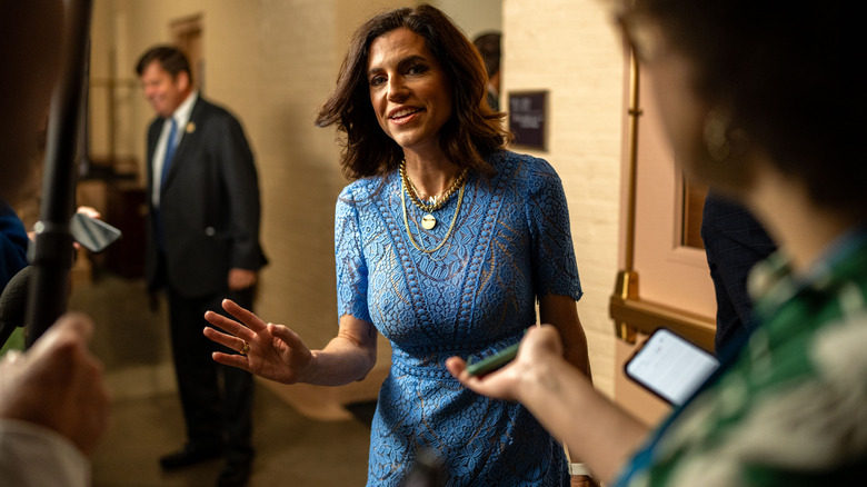 Nancy Mace speaking to reporters in a blue dress