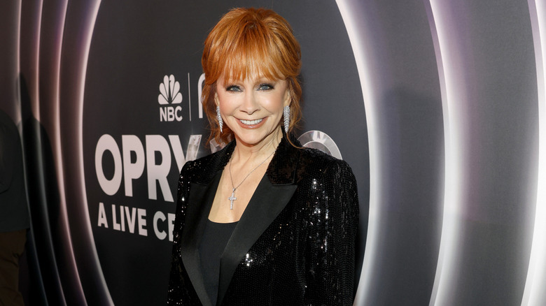 Reba McEntire on red carpet with hair swept back, but very tall on top