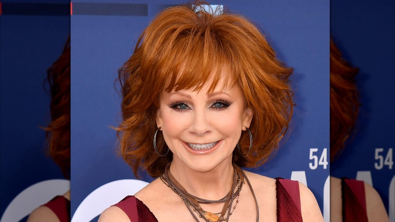 Reba McEntire on red carpet with tall and wide jaw-length hair
