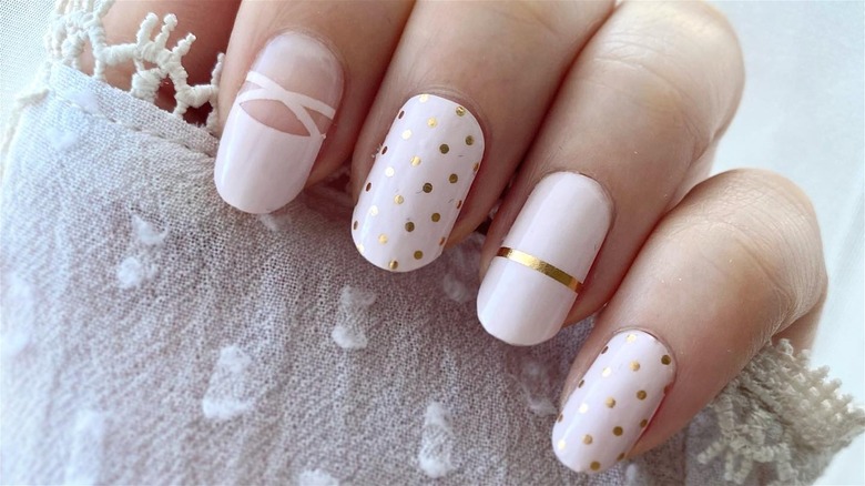 pink-white nails with gold accents