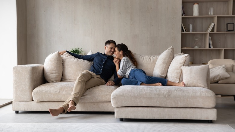 Couple sitting happily on couch
