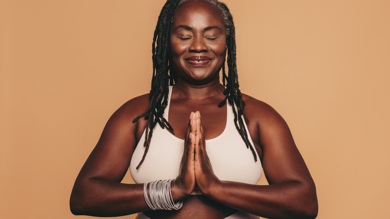 Middle aged woman doing prayer hands