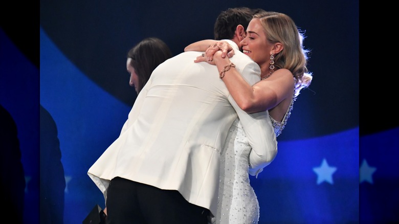 Emily Blunt hugs John Krasinski