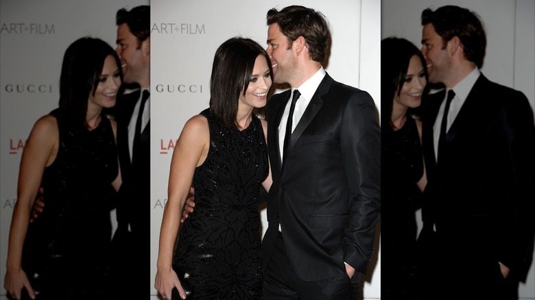 John Krasinski whispers in Emily Blunt's ear
