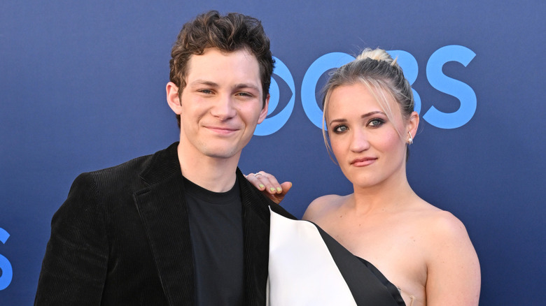 Emily Osment with her hand lightly resting on Montana Jordan's shoulder