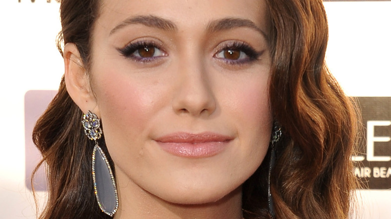 Emmy Rossum with slight smile on the red carpet