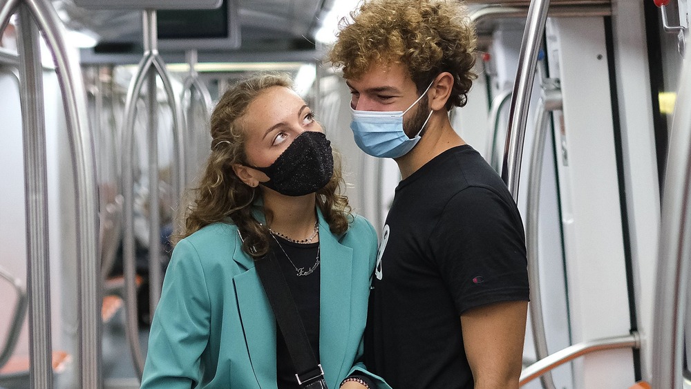 Face masked couple on subway