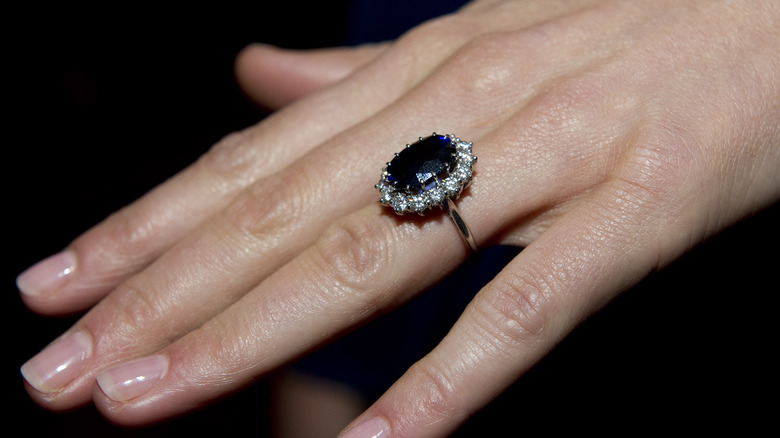 A close up picture of Princess Diana's engagement ring on Kate Middleton's hand