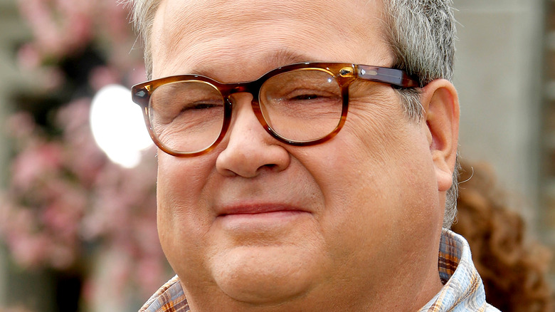 Close up of Eric Stonestreet wearing glasses