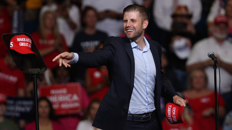 Eric Trump throwing MAGA hats into a crowd