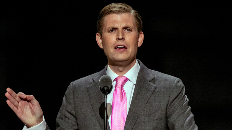 Eric Trump speaking at a microphone