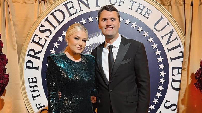 Erika and Charlie Kirk in front of presidential seal