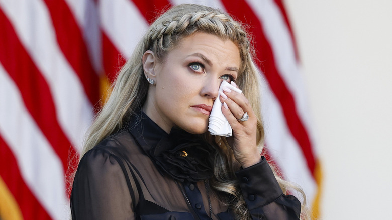 Erika Kirk dabbing her eye with a tissue