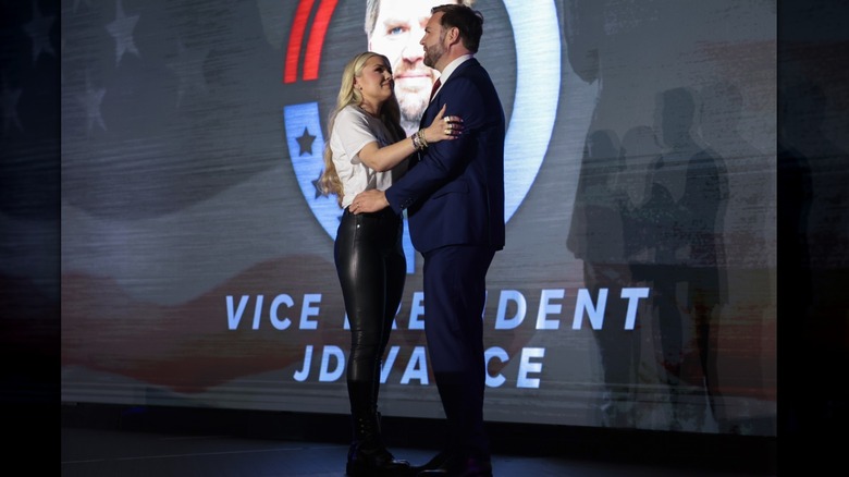 Erika Kirk wearing leather pants embracing JD Vance