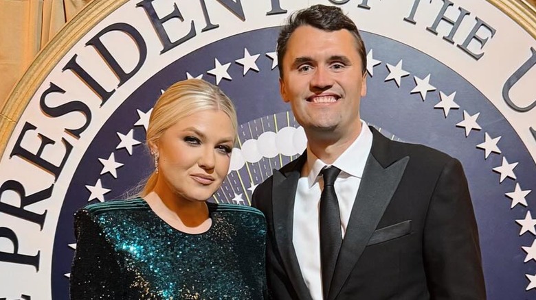 Close up of Erika Kirk and Charlie Kirk in front of presidential seal.