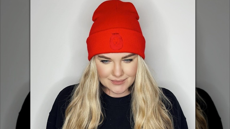 Erika Kirk red beanie looking down