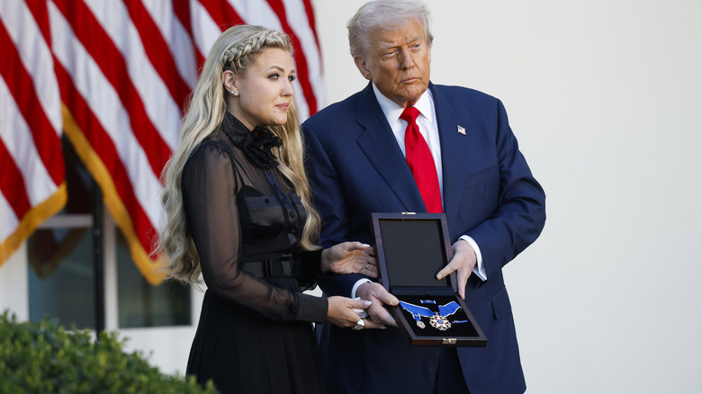 Erika Kirk poses with Donald Trump to receive Charlie Kirk's posthumous Medal of Freedom