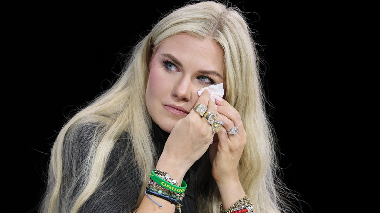 Erika Kirk dabbing her eyes with a tissue