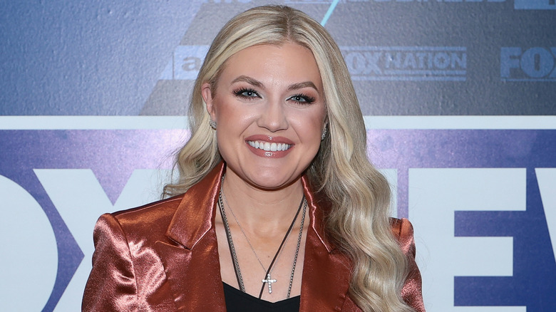 Erika Kirk smiling copper jacket