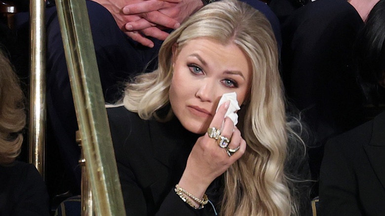 Erika Kirk wiping her eyes with a tissue