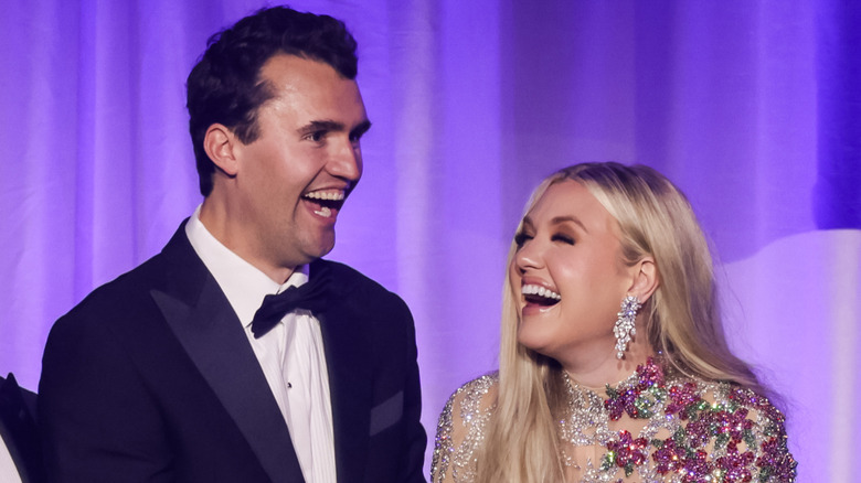 Charlie and Erika Kirk sharing a laugh onstage in their finery