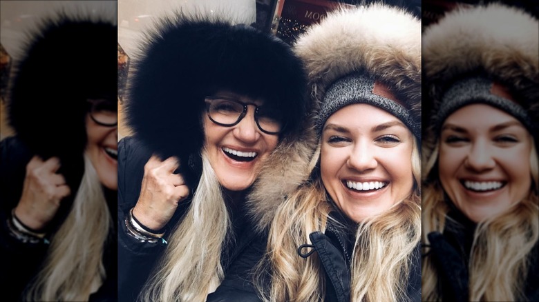 Erika Kirk and Lori Frantzve smiling while taking a selfie together in furry hoods
