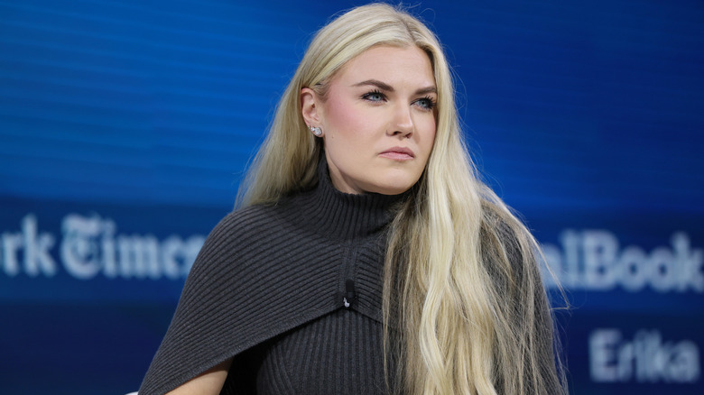 Erika Kirk looking serious in a grey sweater