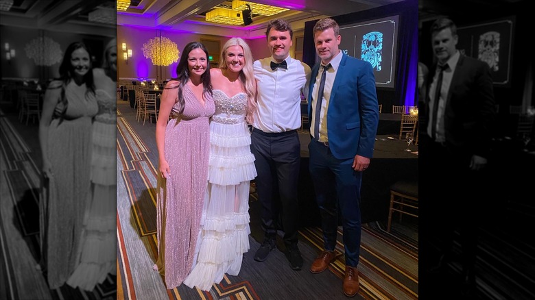 Erika and Charlie Kirk with friends at a wedding reception in 2021