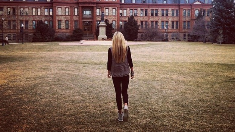 The back of Erika Kirk walking toward Regis University in 2014