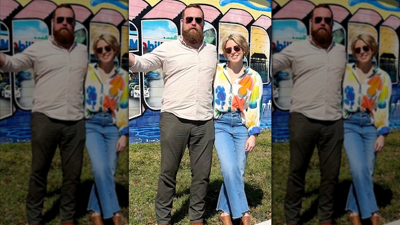 Ben and Erin Napier smiling in front of a building mural