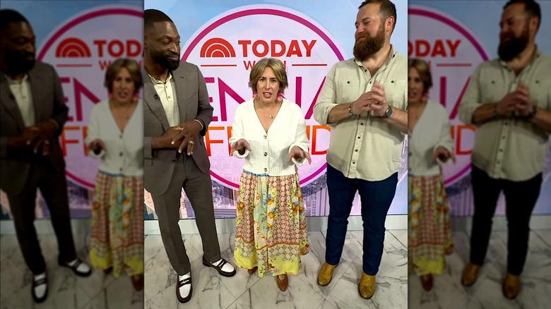 Erin Napier standing between Dwyane Wade and Ben Napier