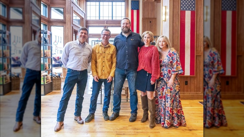 Erin and Ben Napier posing with friends in Laurel
