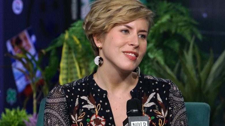 Erin Napier smiling and posing with microphone.