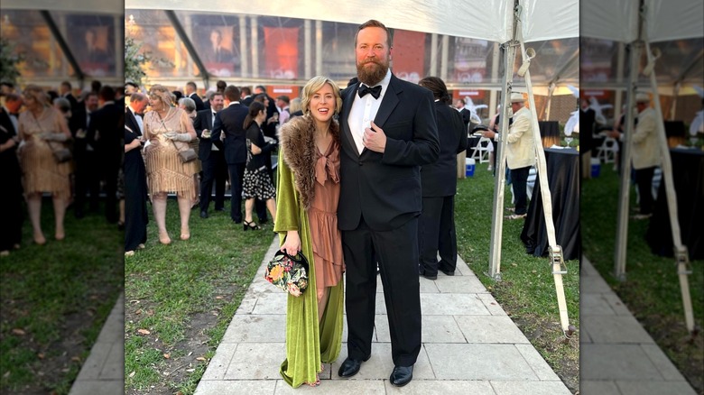 Erin and Ben Napier posing in formal outfits at outside event