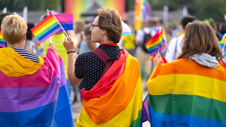 People waving Pride flags