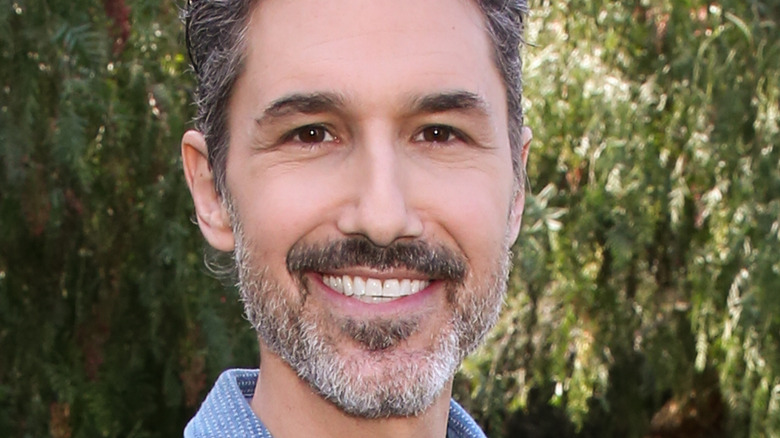 Ethan Zohn posing in front of trees