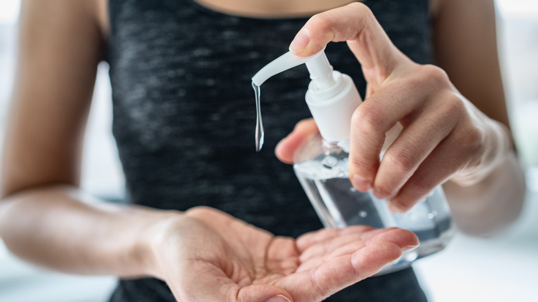 Woman pumping hand sanitiser 