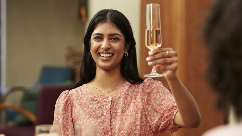 woman raising glass for a toast
