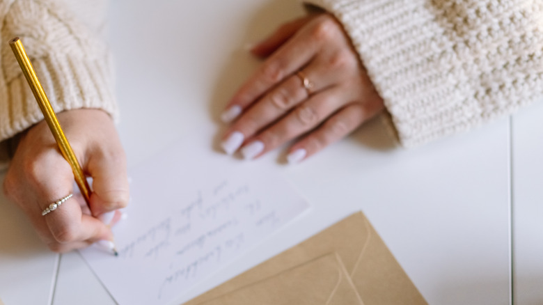 woman writing sympathy card