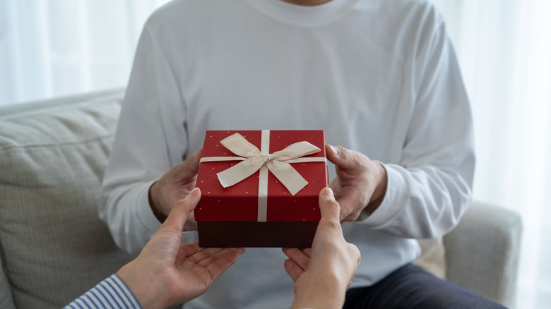 woman giving man a gift