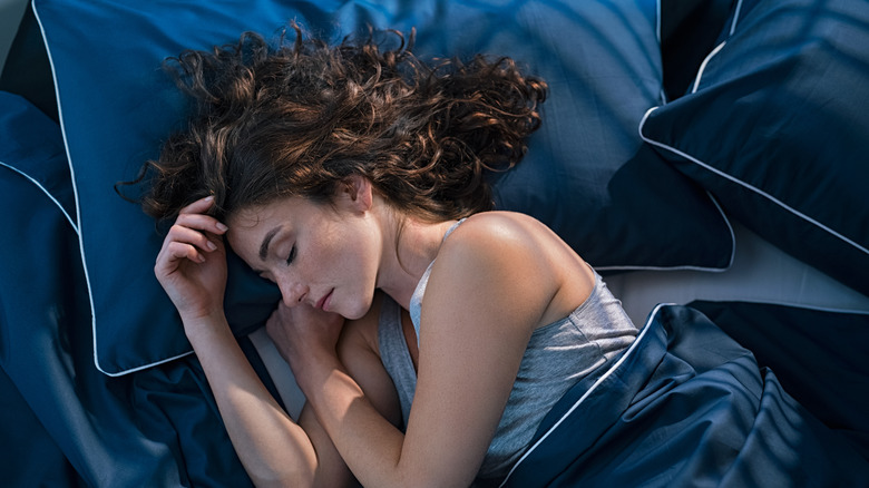 woman peacefully sleeping in bed