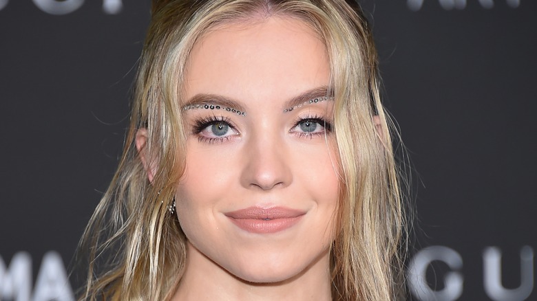Sydney Sweeney on red carpet with sequin eye look