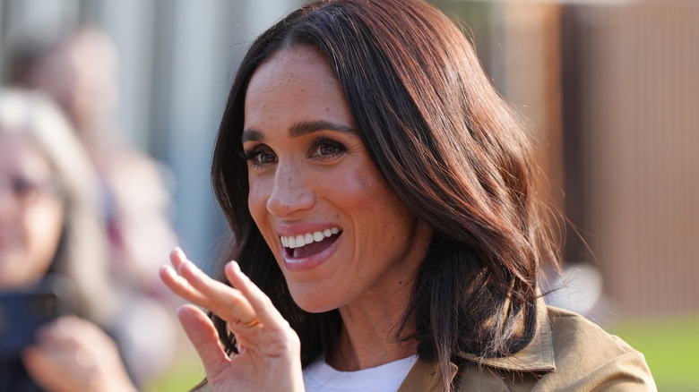 Meghan Markle smiling and waving